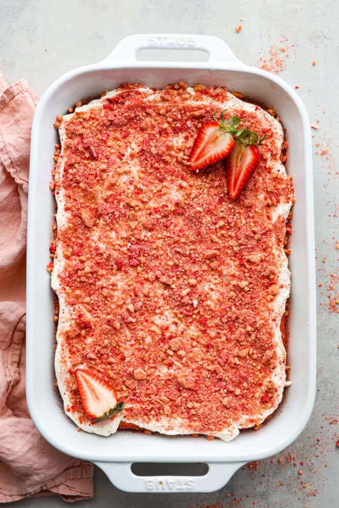 The top view of a finished strawberry crunch cake in a 9x13 baking dish. 