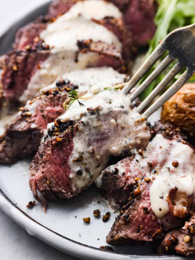 Closeup of sliced steak au poivre.