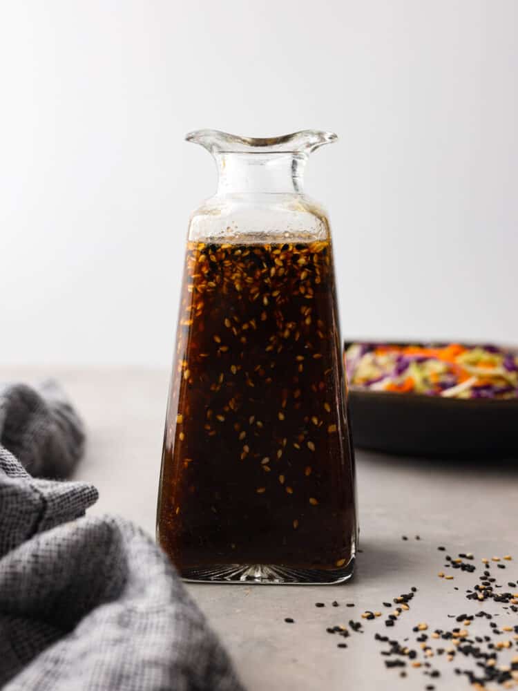 Hero image of Asian salad dressing in a glass bottle.