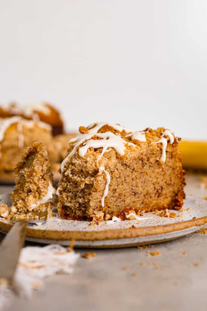 A slice of coffee cake with a bite taken out of it.