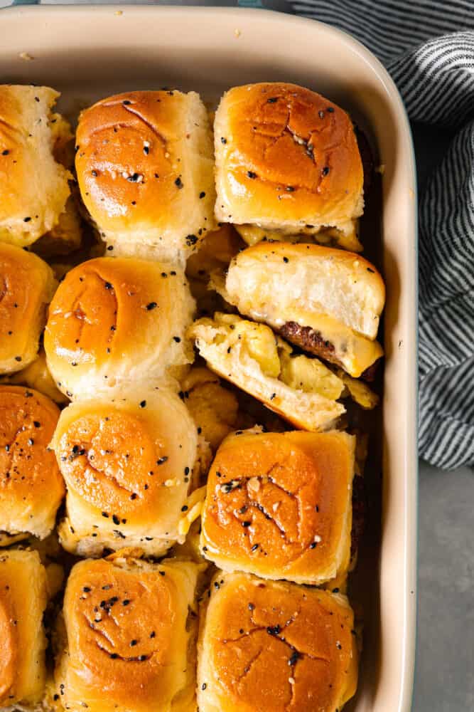 Top-down view of cooked sandwiches, brushed with butter and topped with everything bagel seasoning.