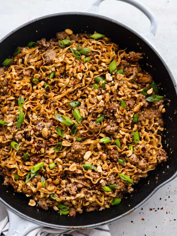 Top-down view of dan dan noodles in a skillet.