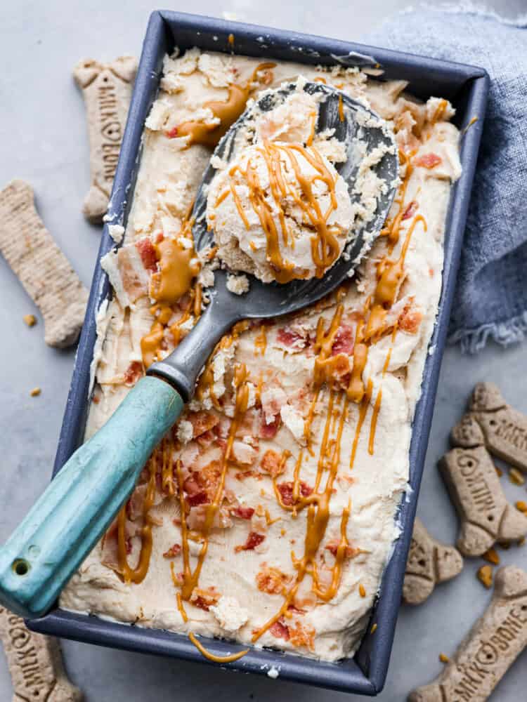 Dog ice cream in a bread pan with a scoop taken out of it.