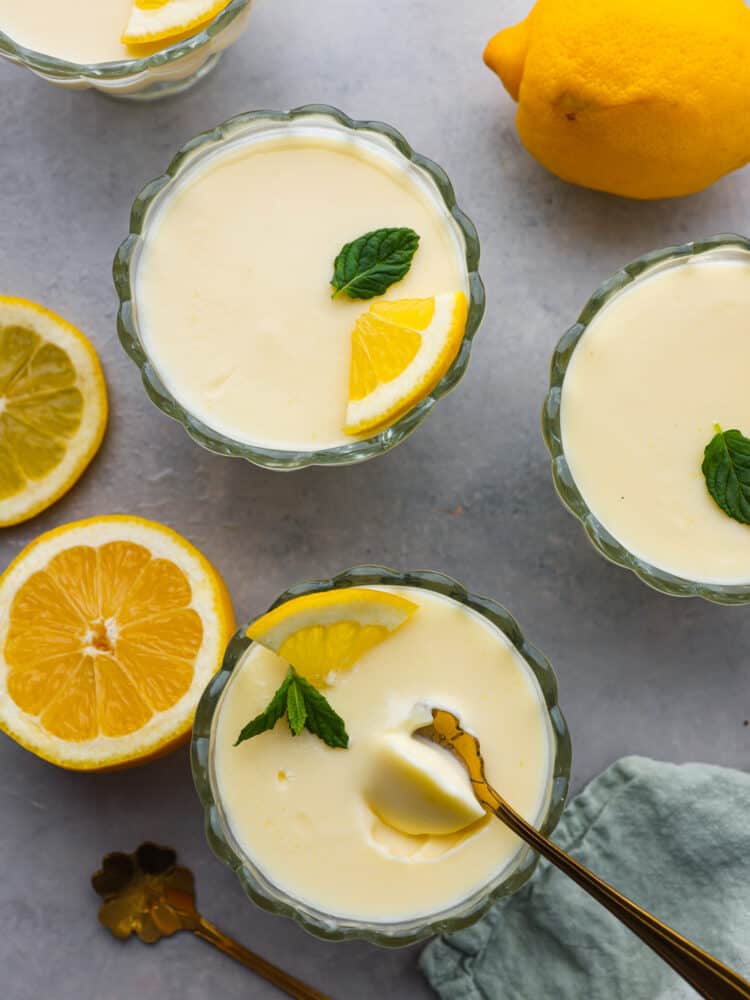 Top-down view of glass cups filled with a creamy lemon filling.