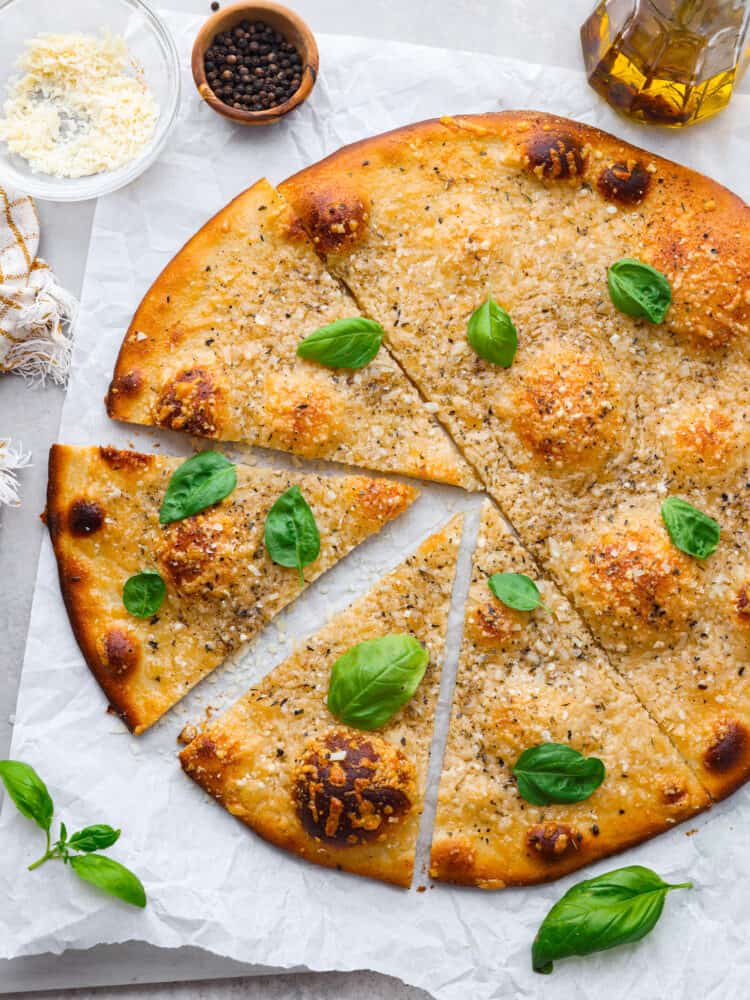 Hero image of a cacio e pepe pizza cut into slices.