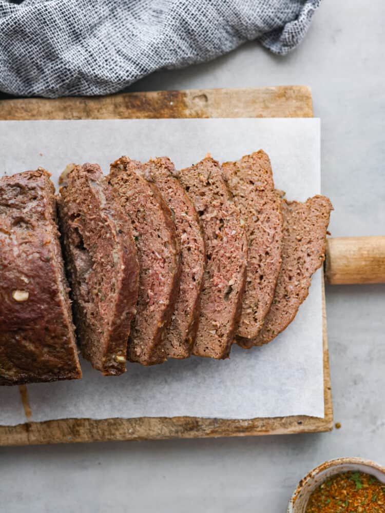 Sliced gyro meat on a wooden board.