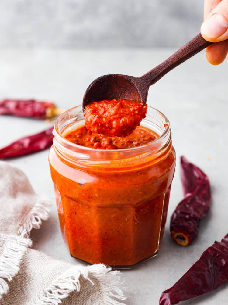 Hero image of harissa paste in a glass jar.