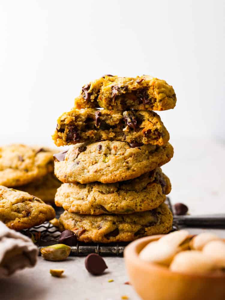 A stack of 4 cookies, with one broken in half.