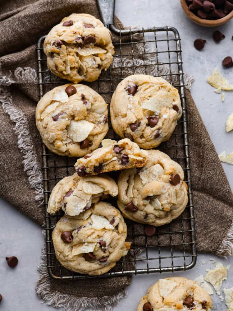 Overhead view of potato chip cookies on a cooling rack and brown towel.