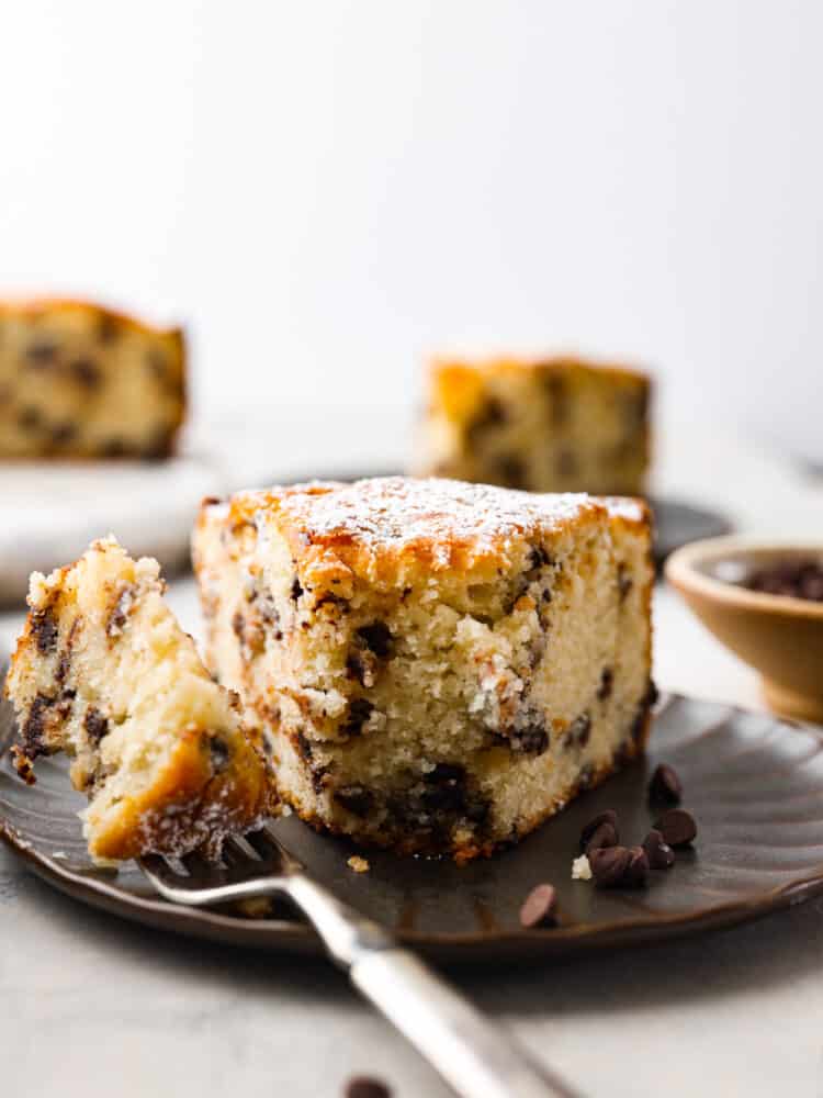 A slice of cake on a brown scalloped plate.