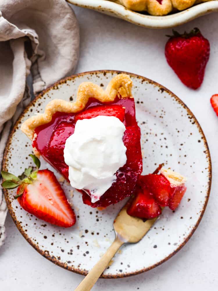 Top-down view of a slice of pie, topped with whipped cream.