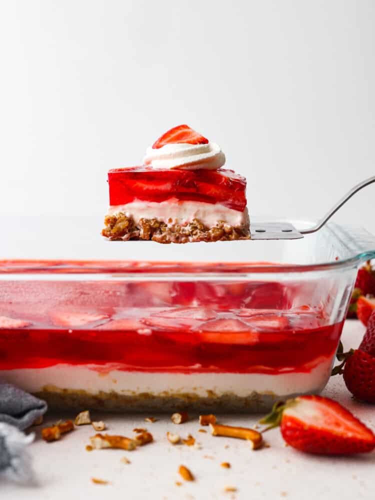 A slice of the strawberry dessert being served.