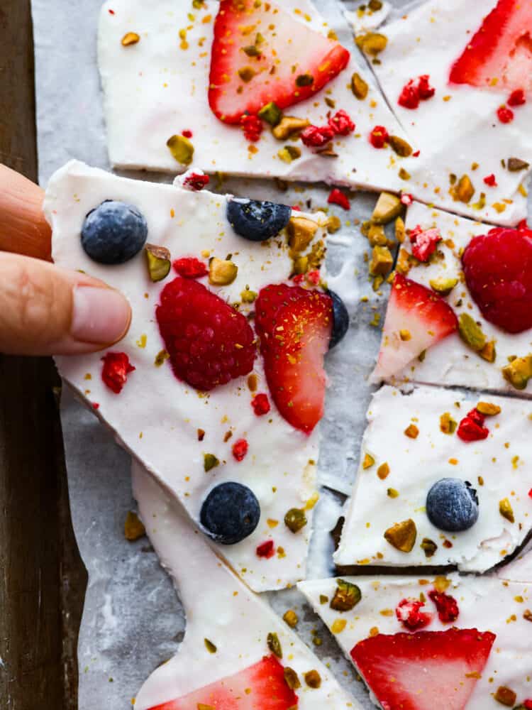 Picking up a piece of frozen yogurt bark.