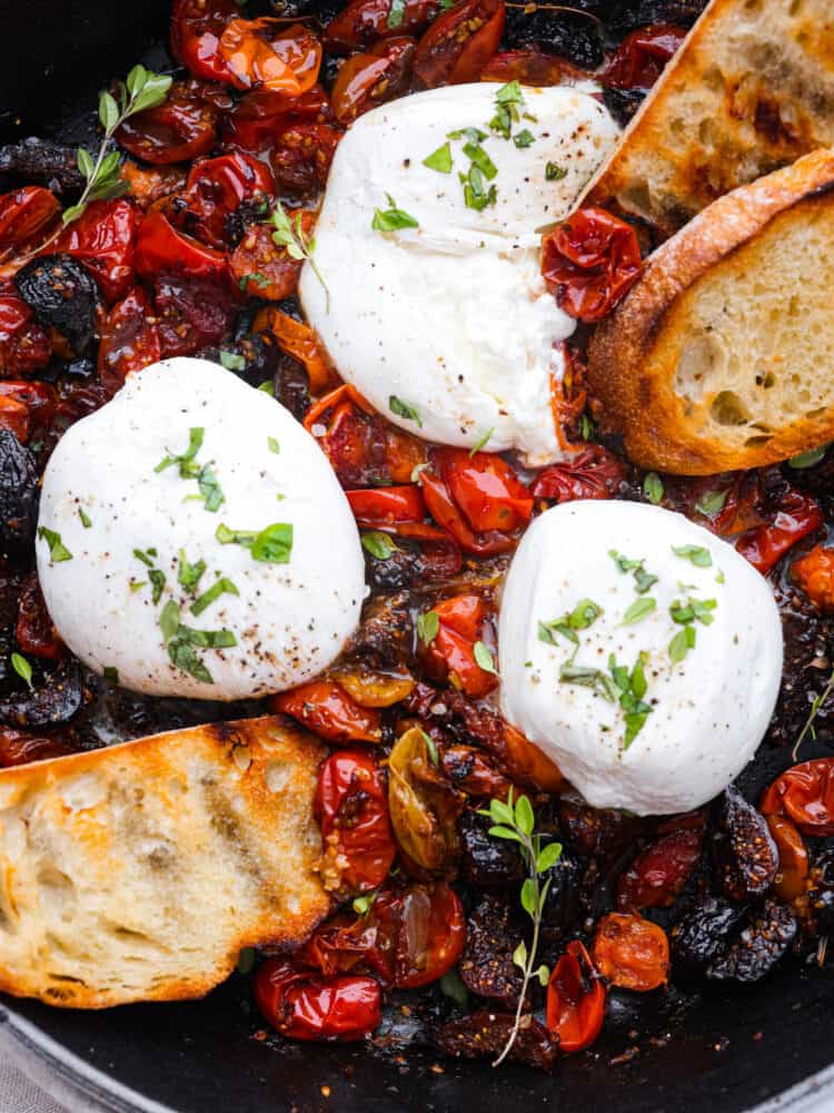 Closeup of a tomato and burrata appetizer.