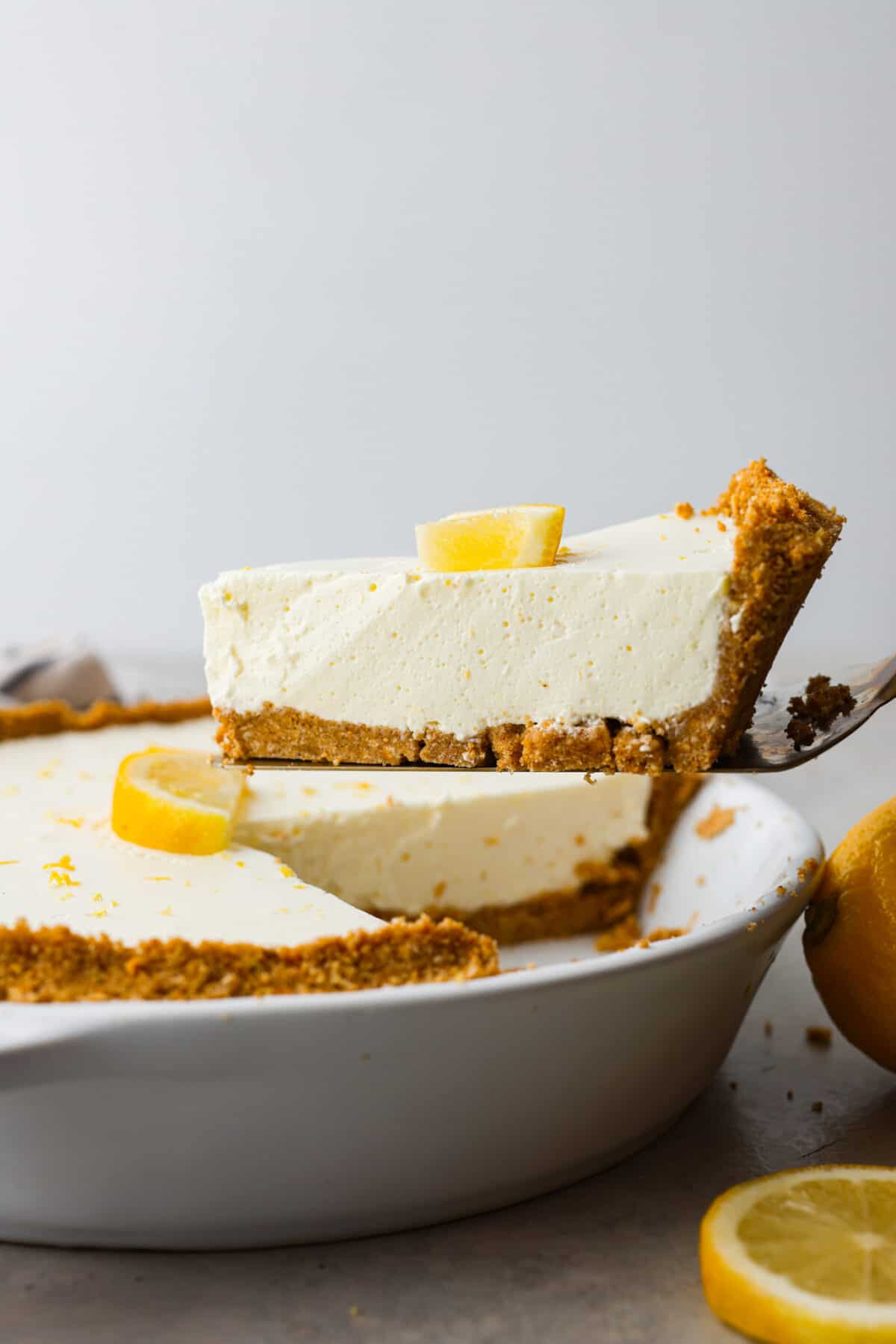 Close side view of a piece of pie being lifted up with a spatula.