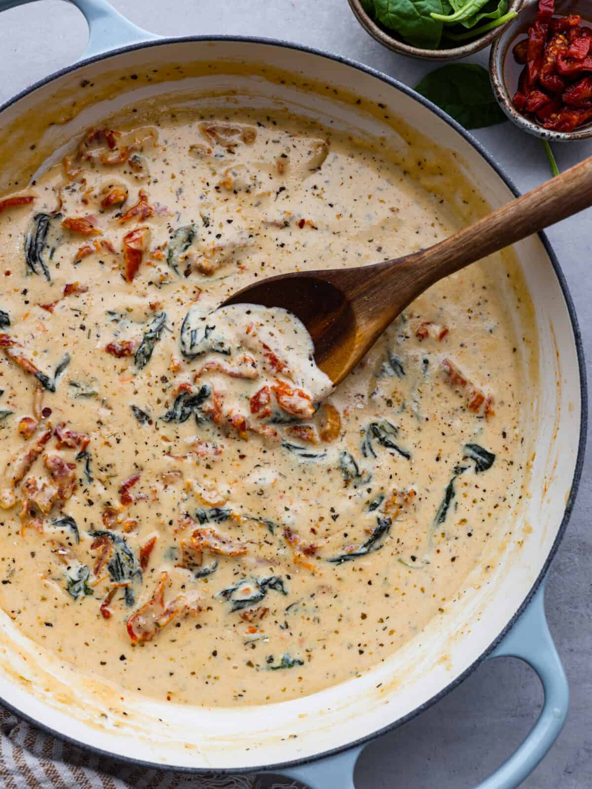 Tuscan garlic sauce in a blue and white saucepan.