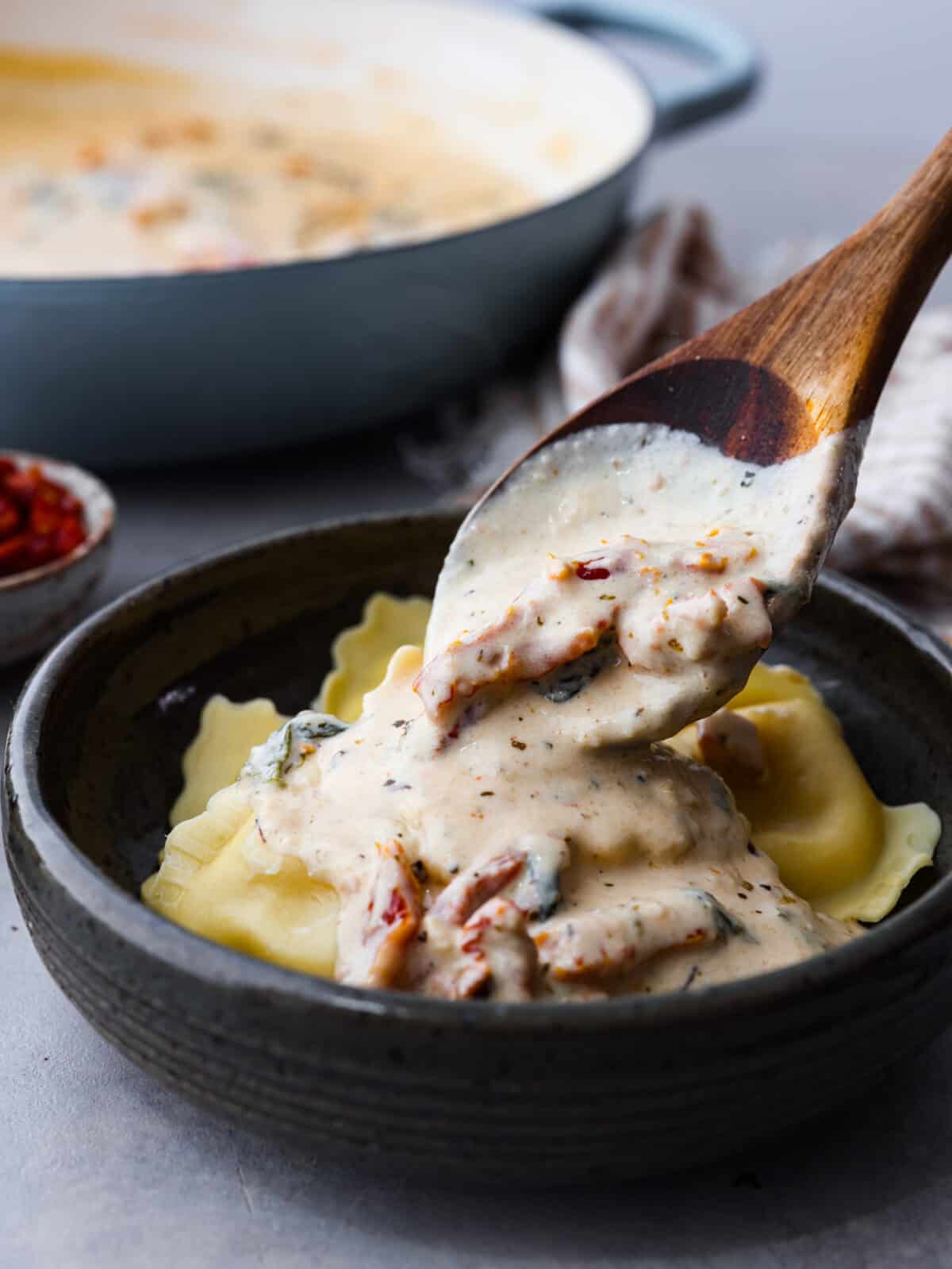 Pouring sauce over ravioli.