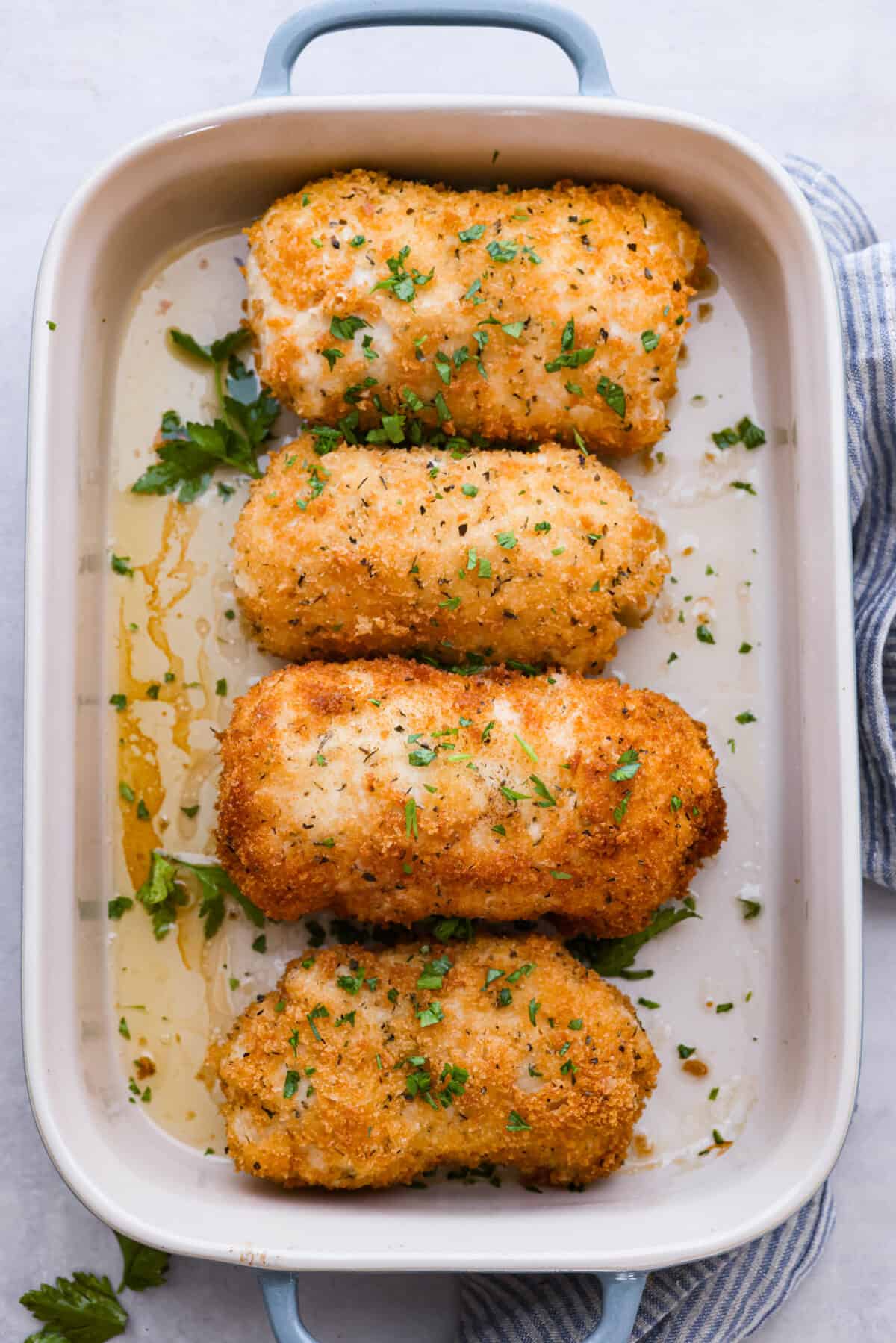 Top-down view of the chicken in a blue and white casserole dish.