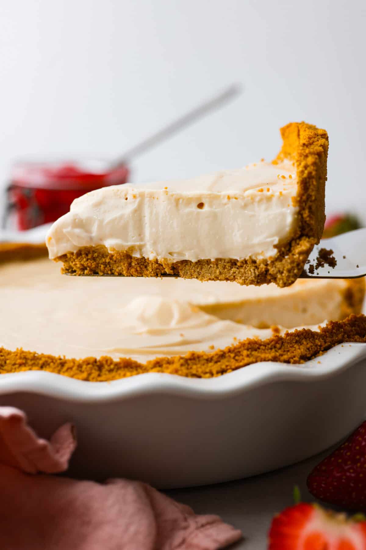 A slice of cream cheese pie being served. 