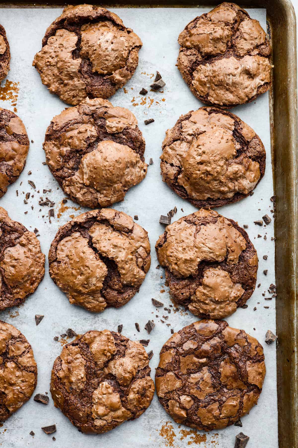 Baked flourless chocolate chip cookies on a baking sheet with parchment paper. 