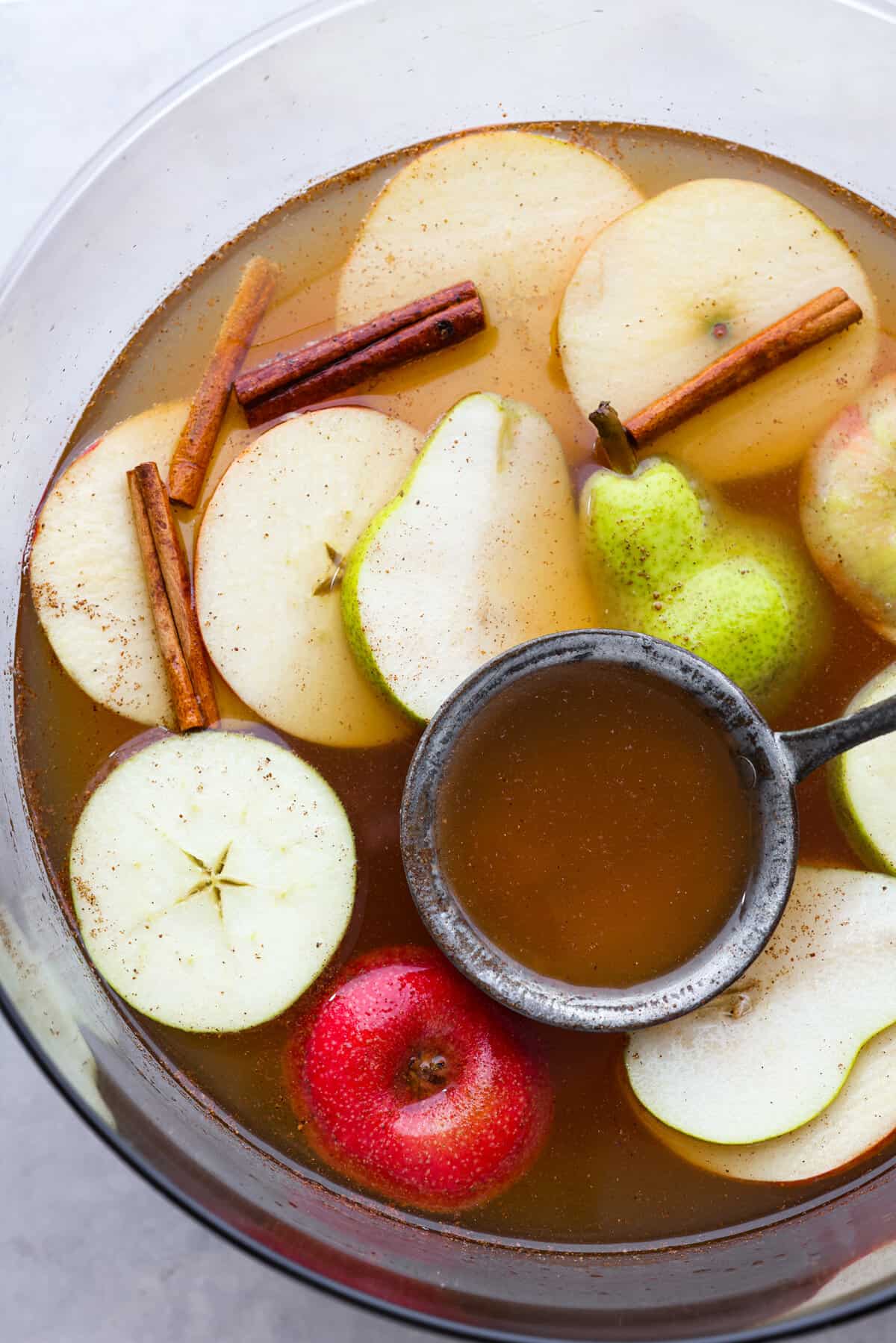 Top-down view of the drink served in a punch bowl, garnished with fruit slices.