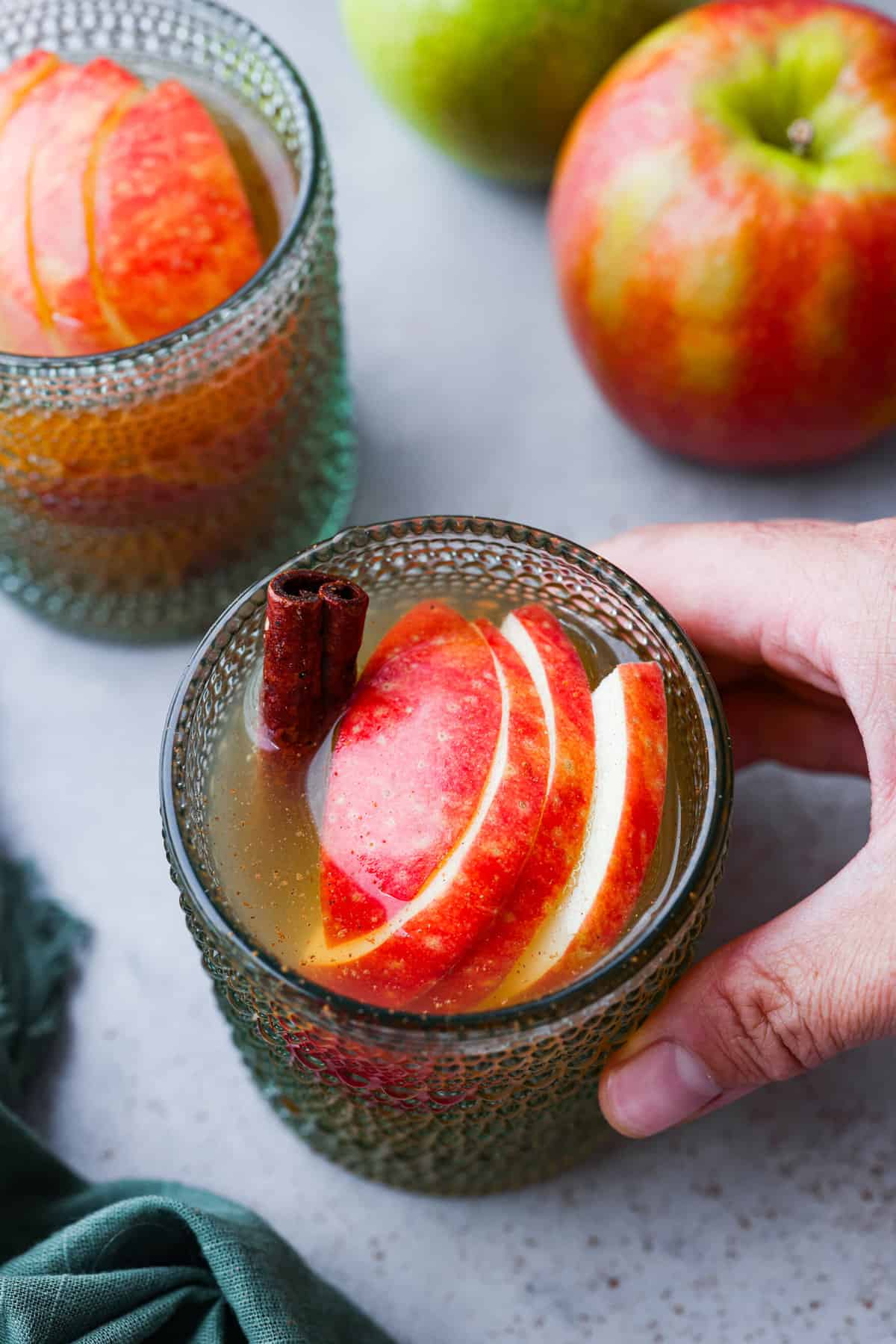 A glass of punch being picked up.