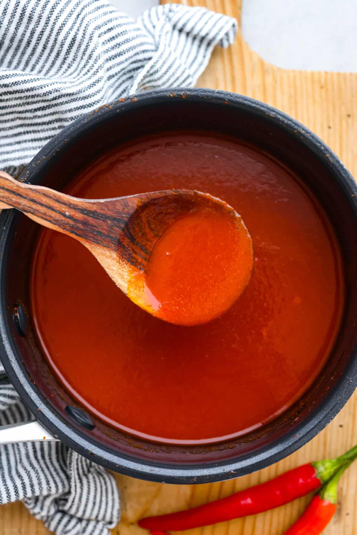 Sriracha sauce after being cooked in a large pot.