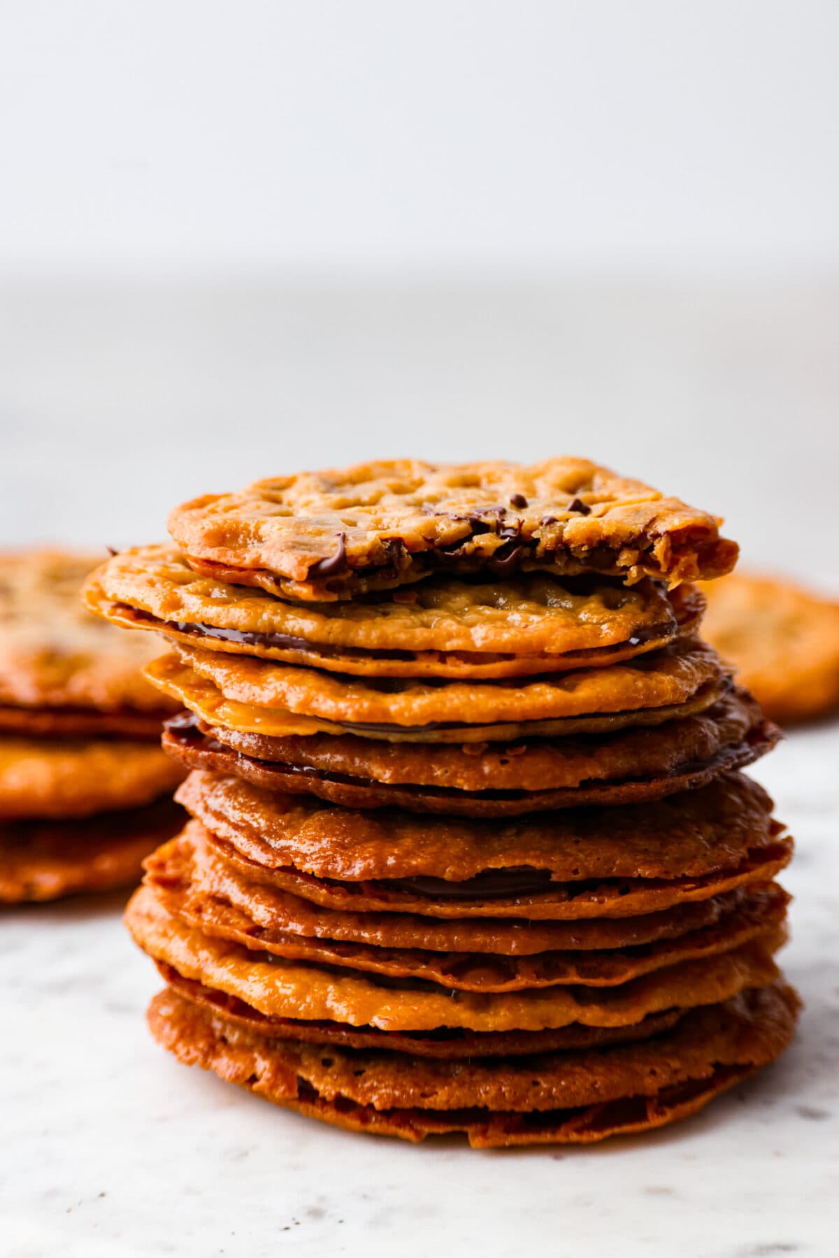 8 cookies stacked on top of each other. The top cookie has a bite taken out of it.