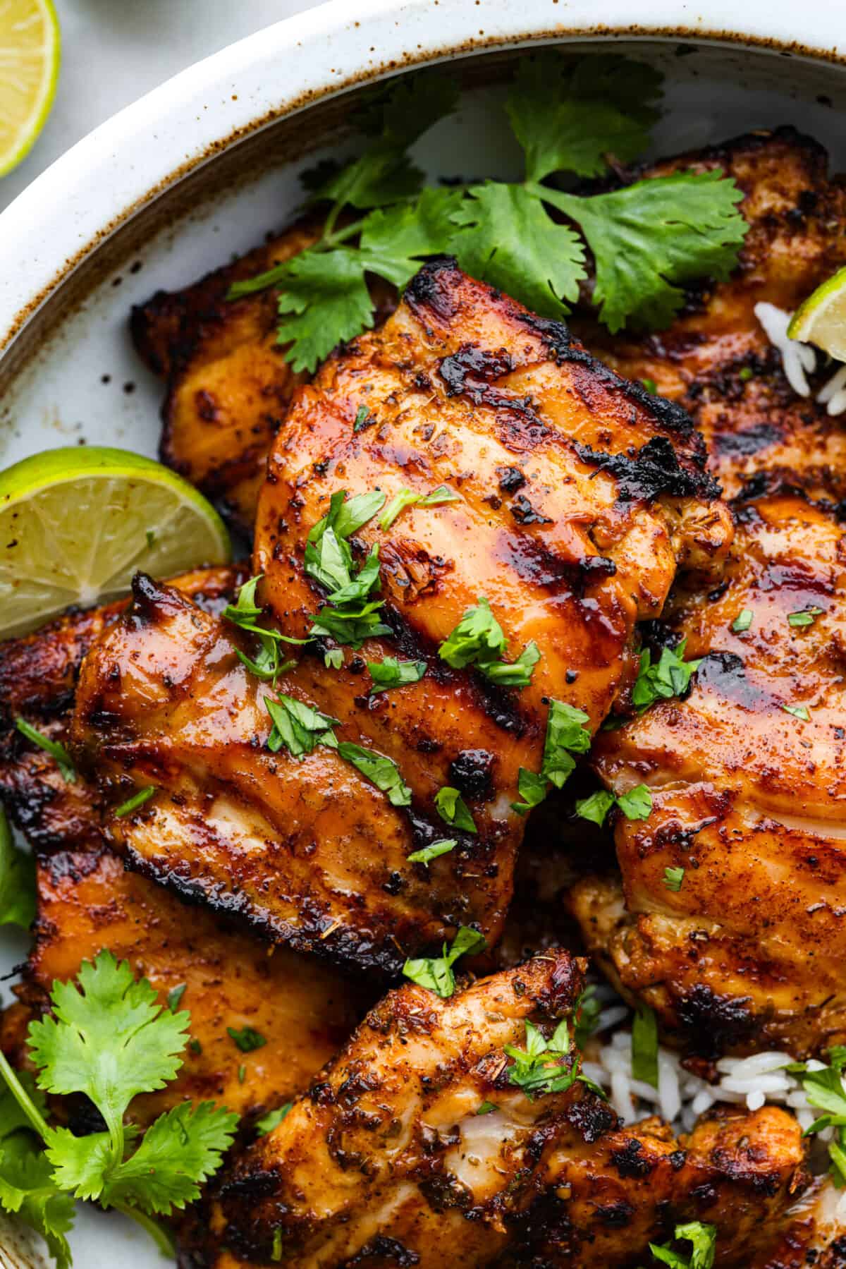 Closeup of pollo asado, garnished with herbs.