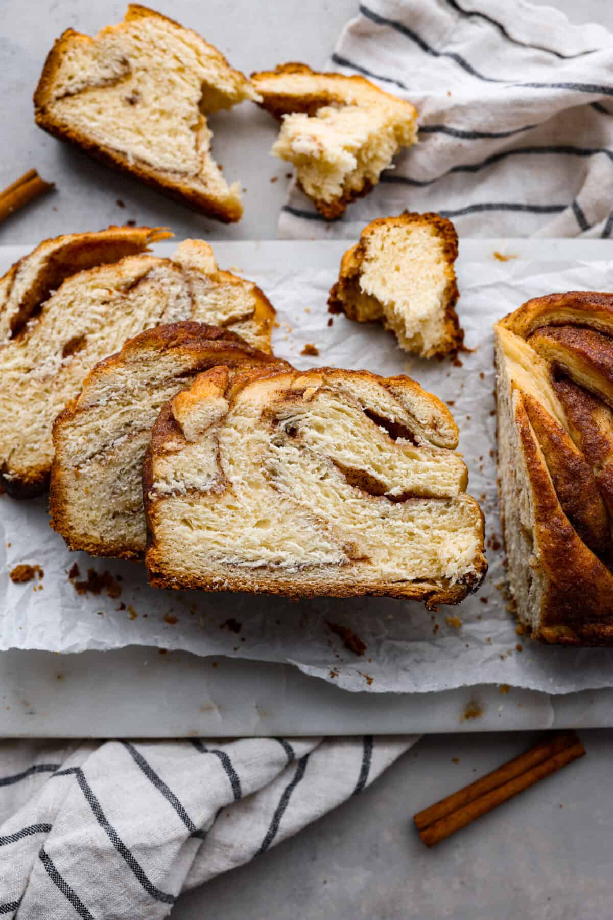 sliced cinnamon babka bread on parchment paper. 