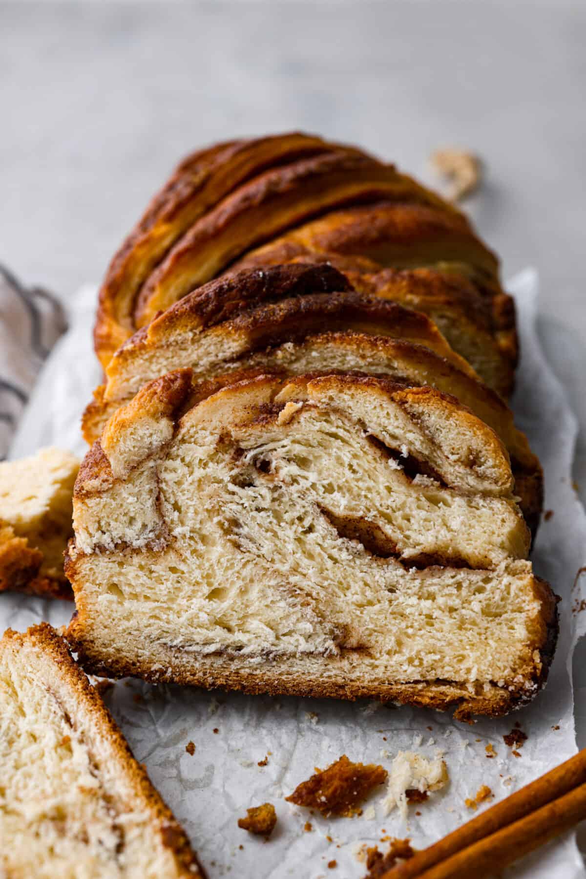 A loaf of cinnamon babka sliced so you can see the cinnamon swirls. 