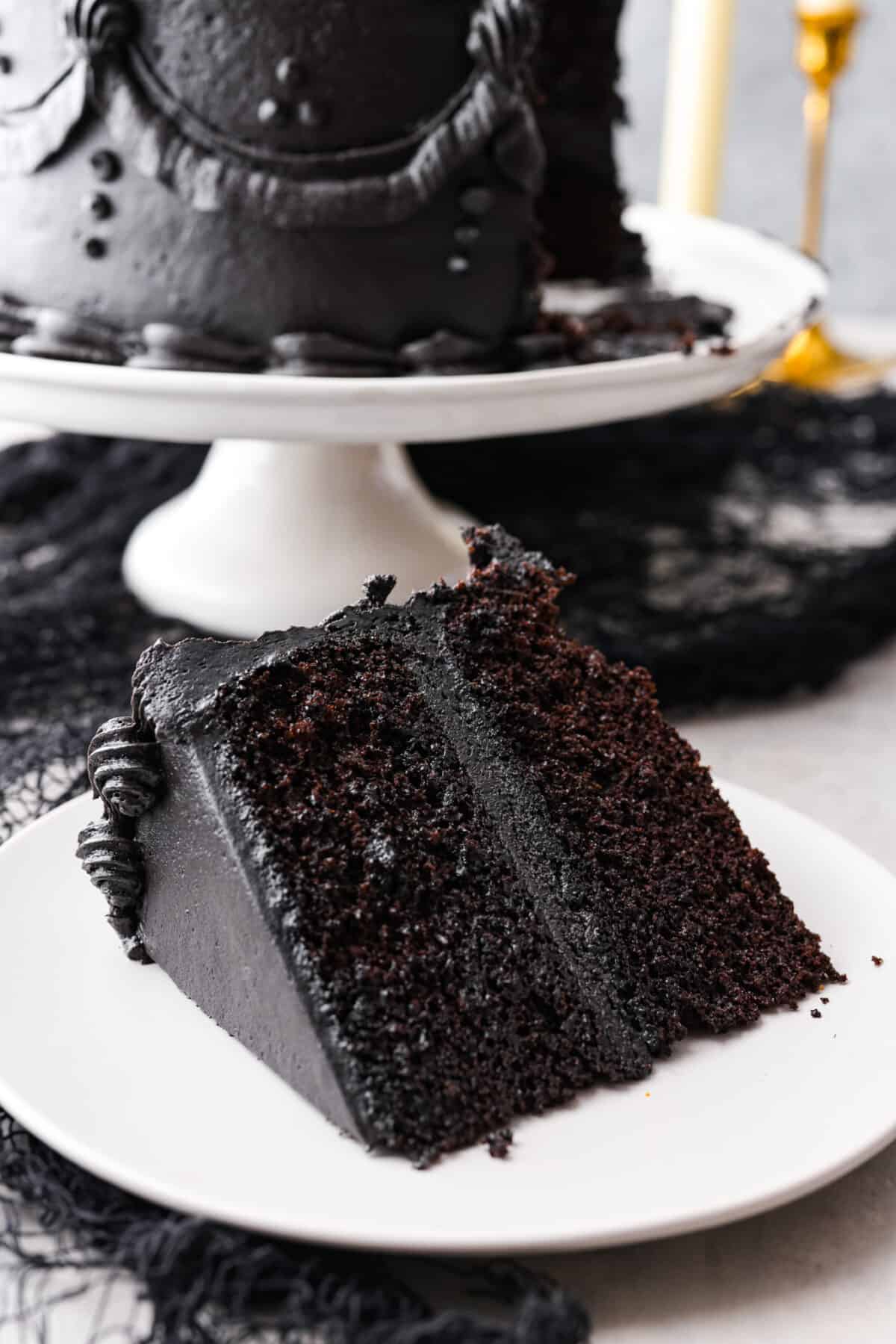 Closeup of a slice of cake served on a small white plate.