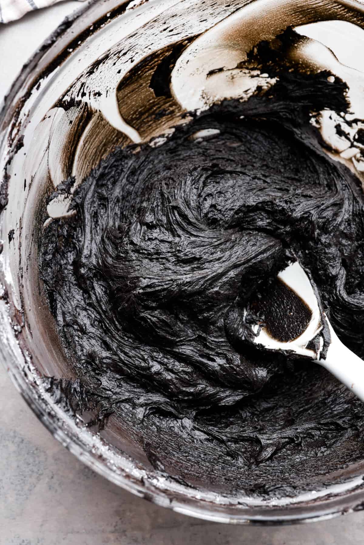 Overhead shot of a bowl of black frosting. 