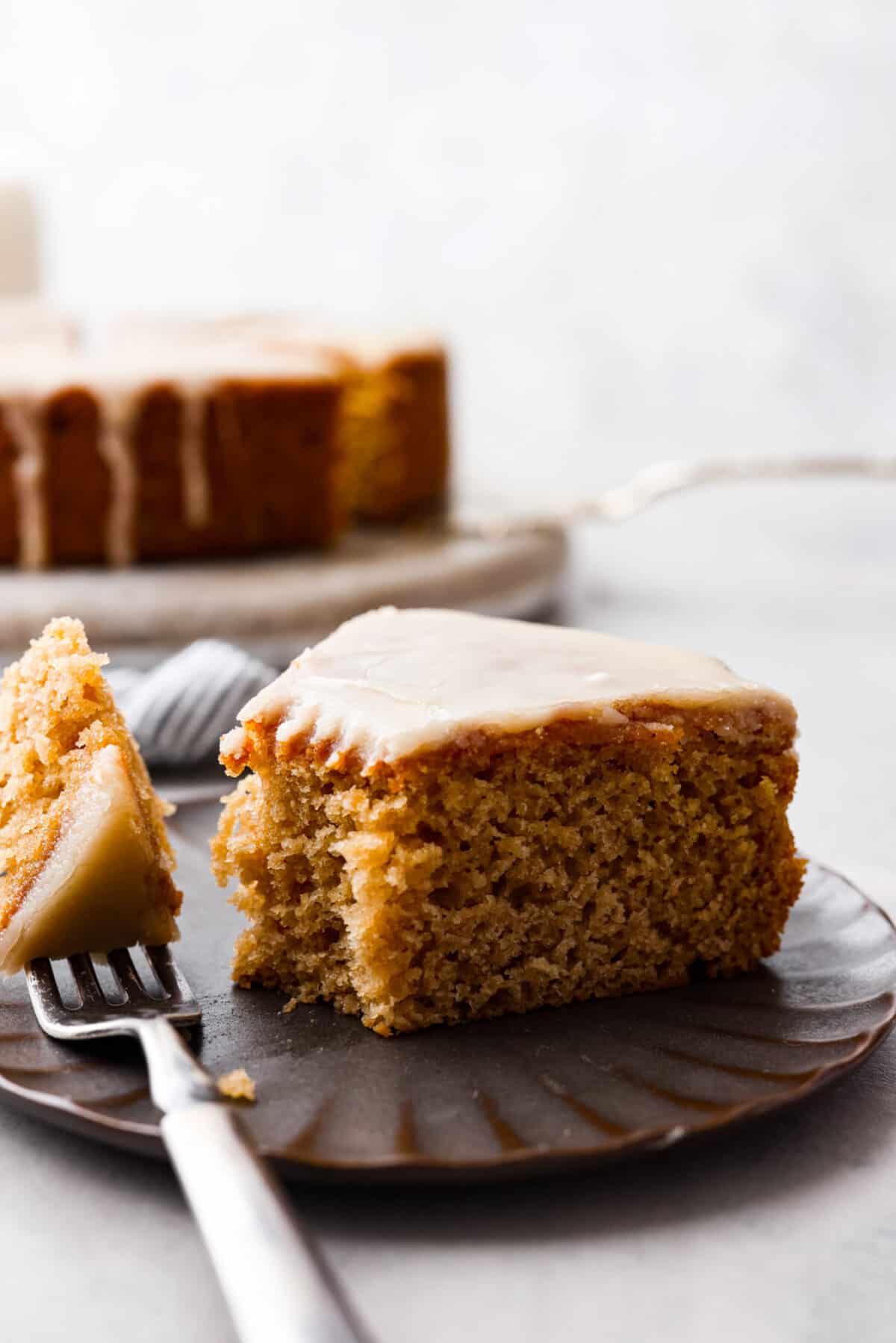 A slice of cake with a bite taken out of it.