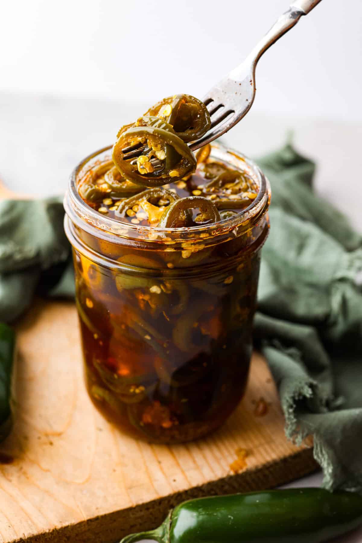 Picking up a candied jalapeno with a fork.