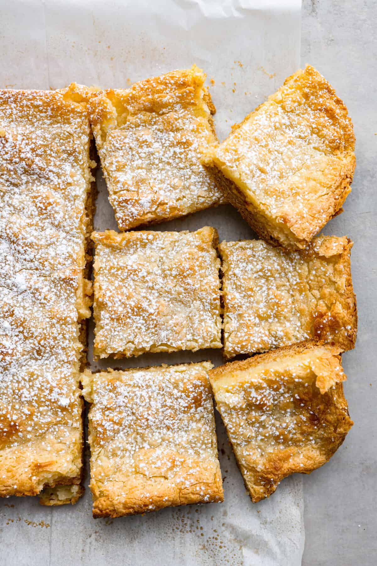 Top-down view of ooey-gooey butter cake cut into slices.