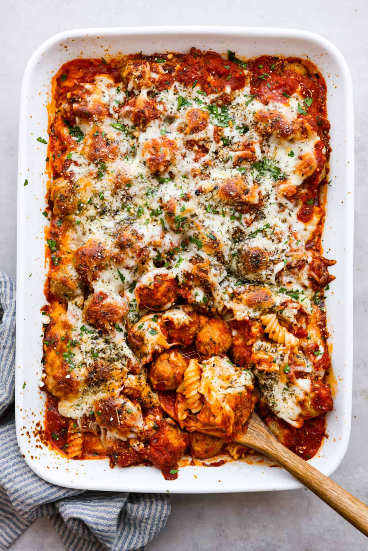 Top-down view of meatball casserole in a white baking dish.