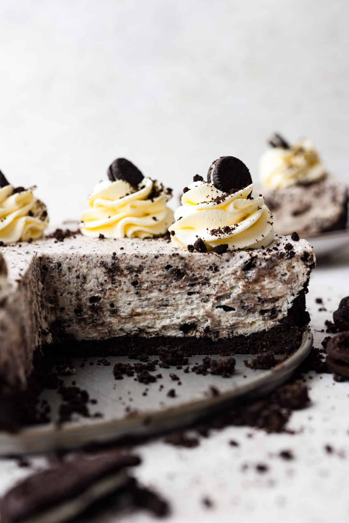 No Bake Oreo Cheesecake with a slice cut out of it.