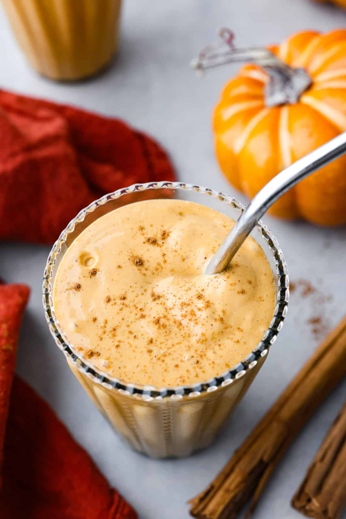 Top-down view of a smoothie with a metal straw in it.