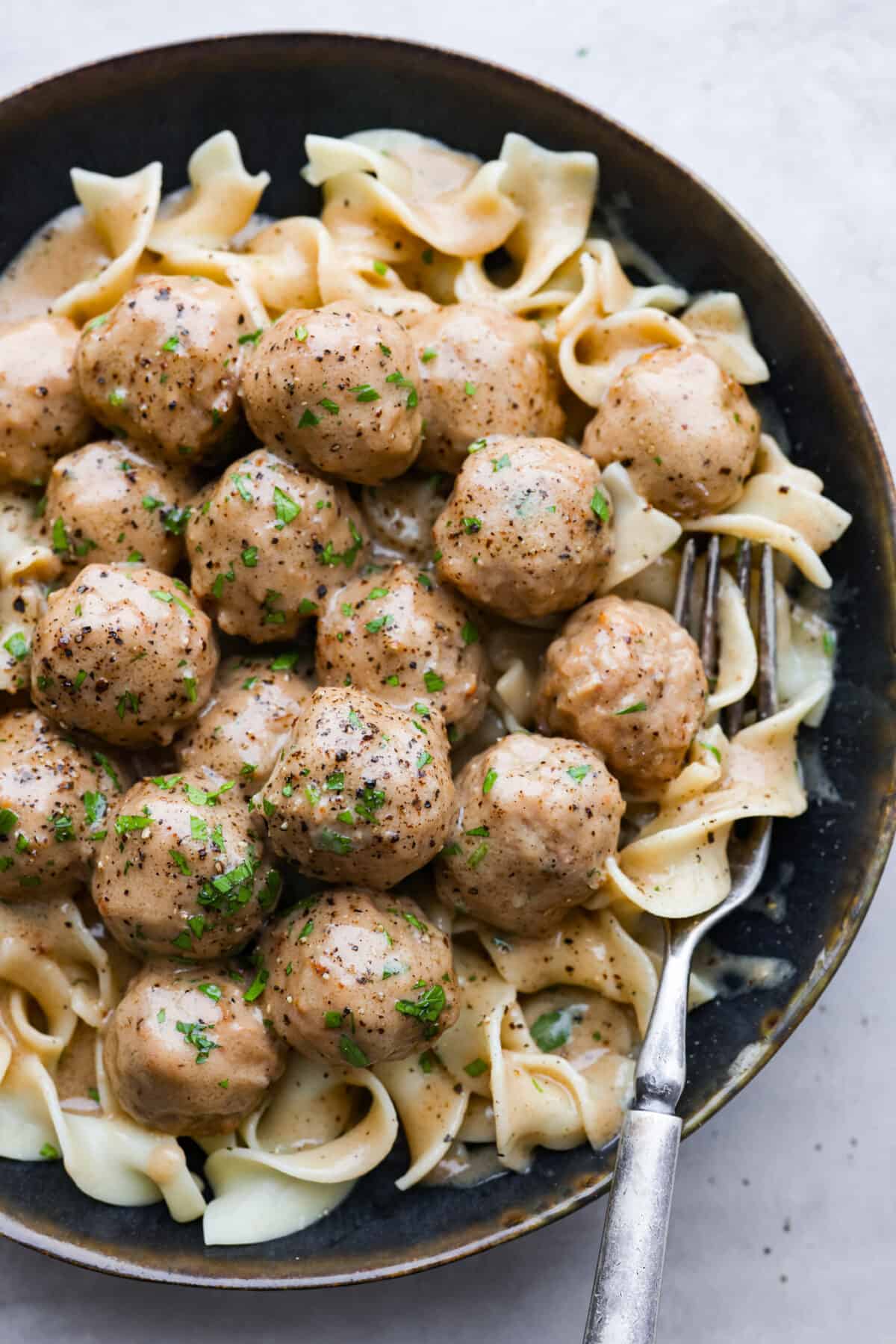 Overhead shot of plated Swedish meatballs over egg noodles. 