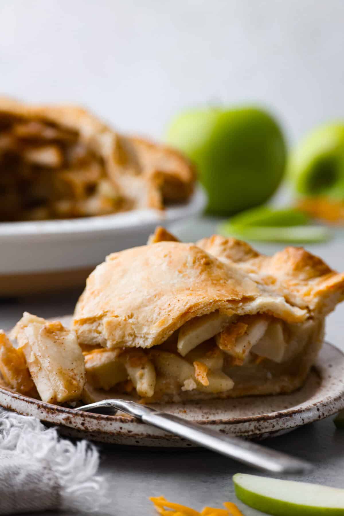 A slice of pie on a plate with a silver fork. 