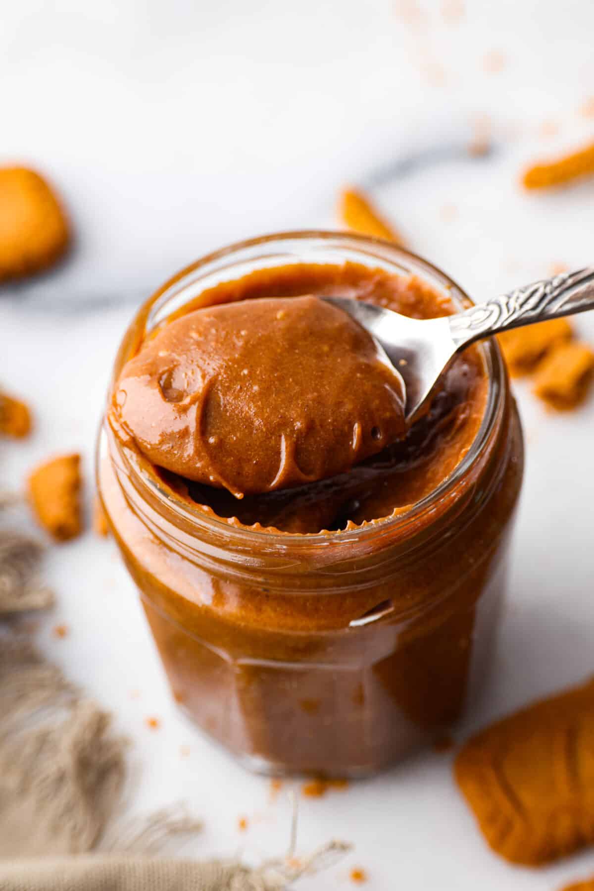 Cookie butter being scooped out with a spoon. 