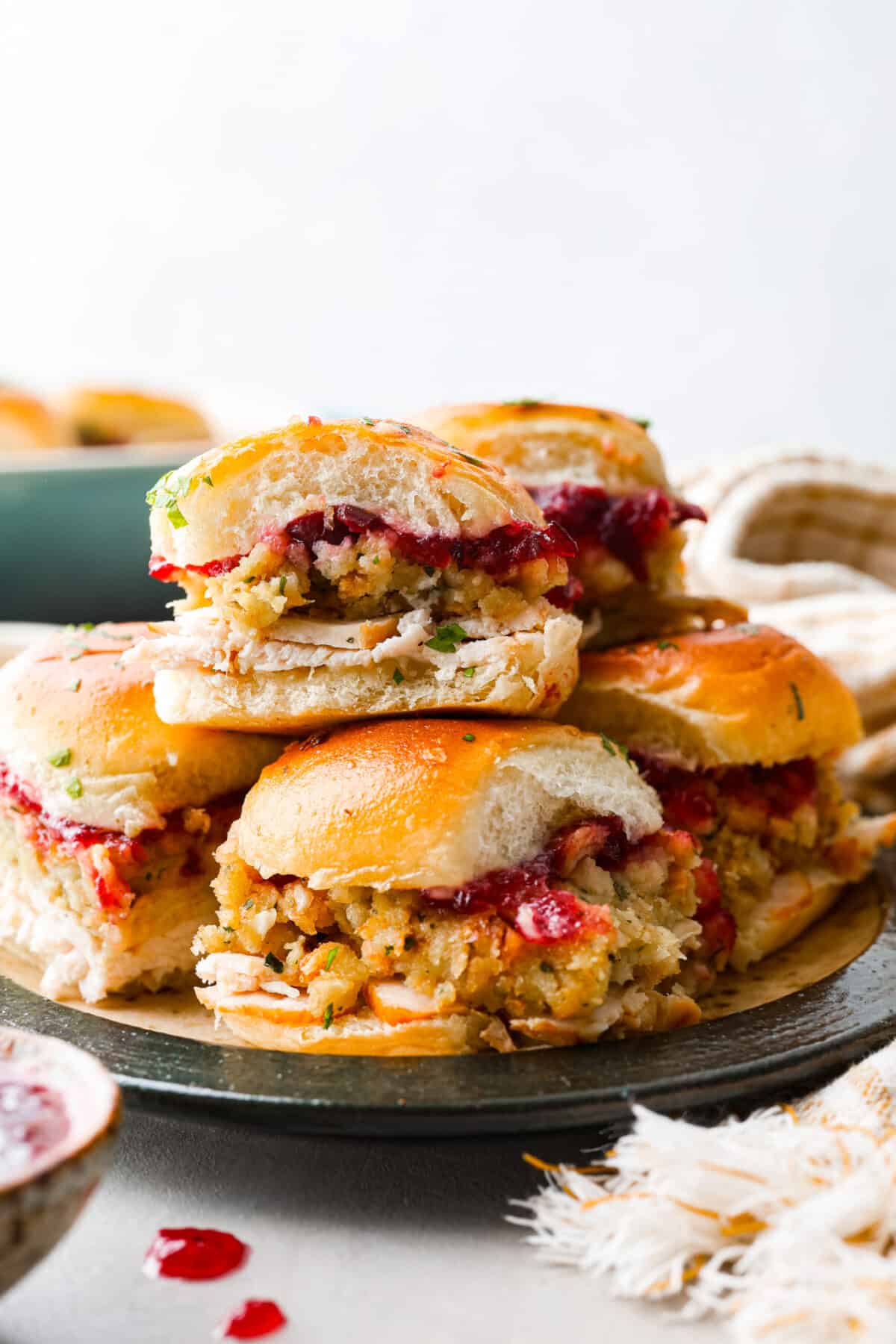 Side shot of a stack of turkey cranberry sliders.