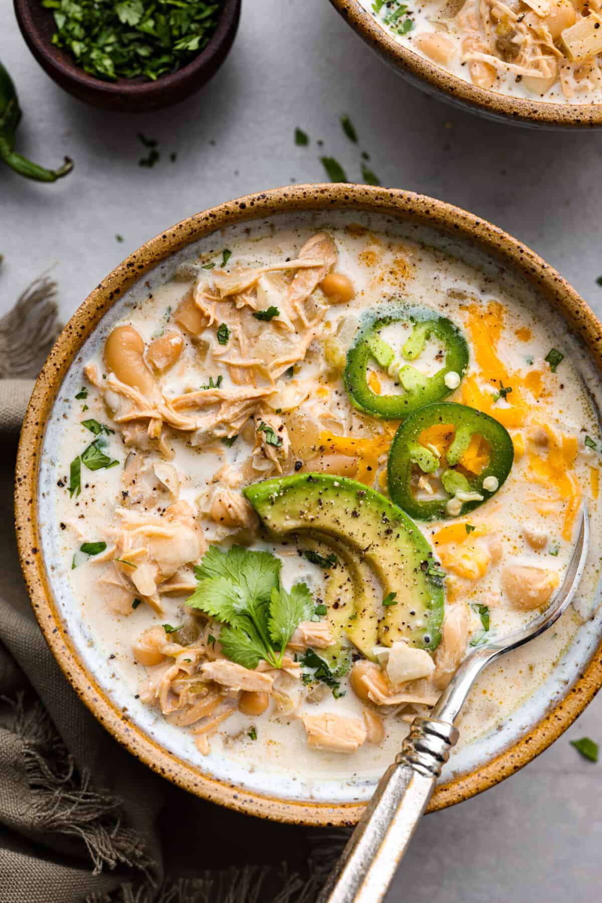 The top view of crockpot white chicken chili in a bowl. 