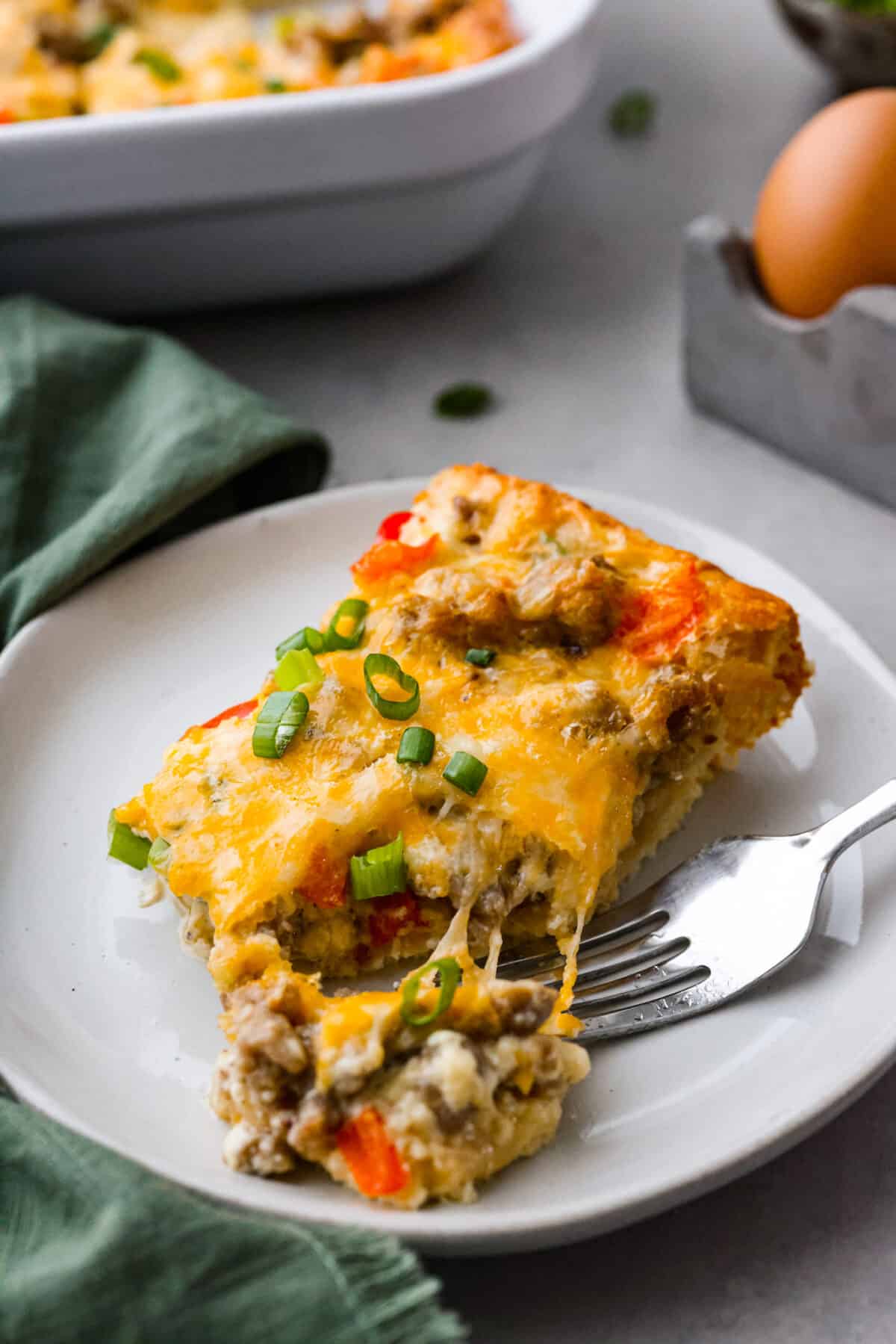 A slice of casserole served on a white plate.