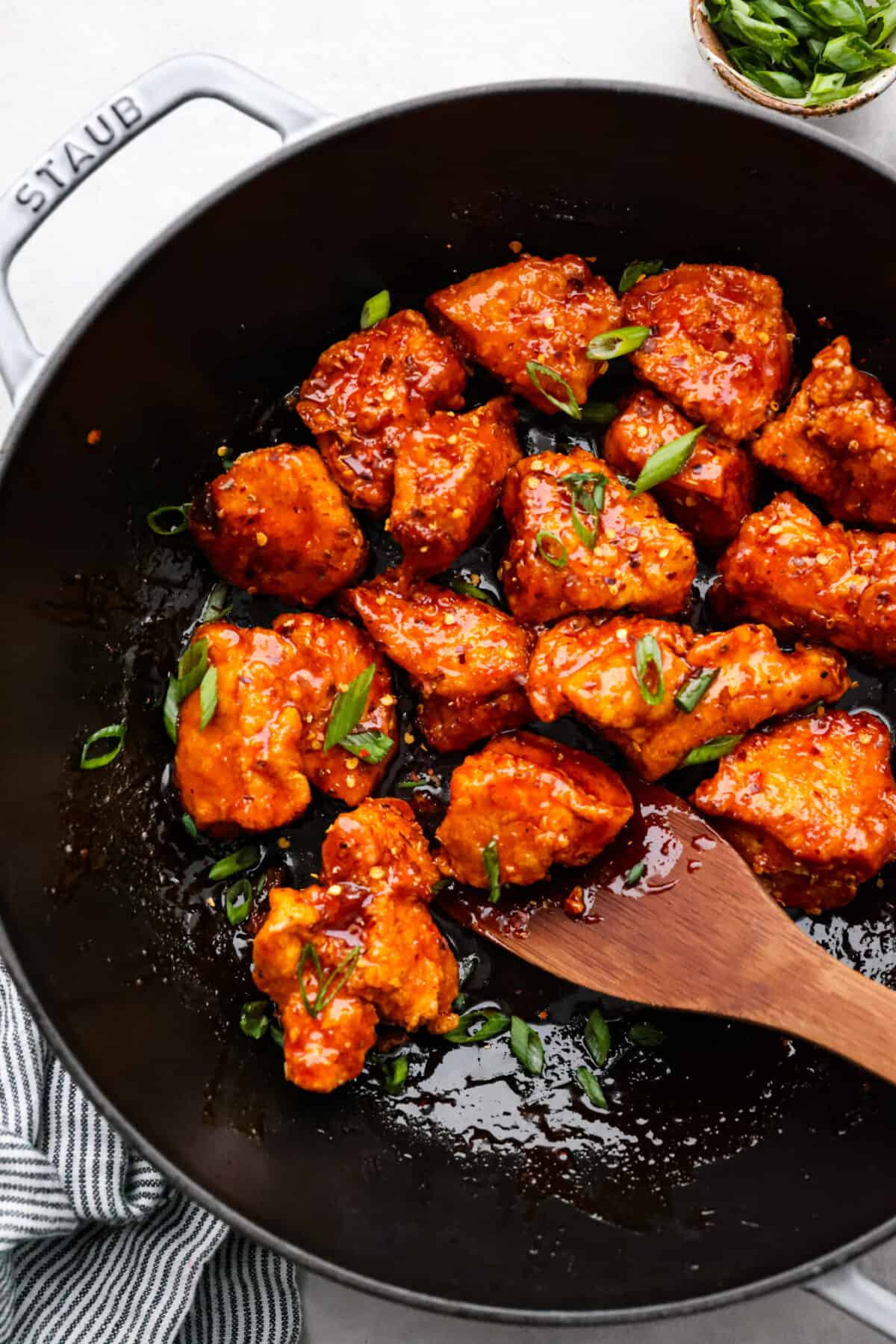 Fried chicken pieces in a skillet.