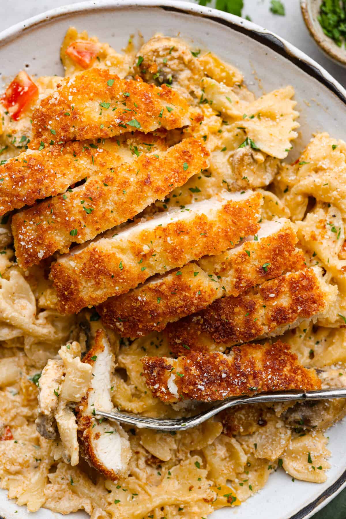 Closeup of sliced, breaded chicken.