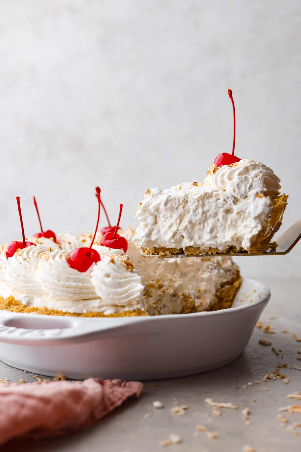 Serving a slice of million dollar pie with a metal cake spatula.