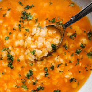 Pastina served in a white bowl with a spoon.