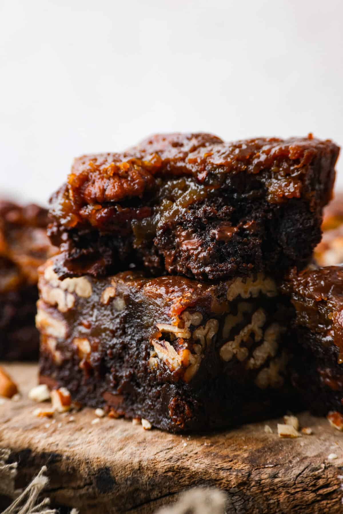 Close up shot of pecan pie brownies stacked on each other. 